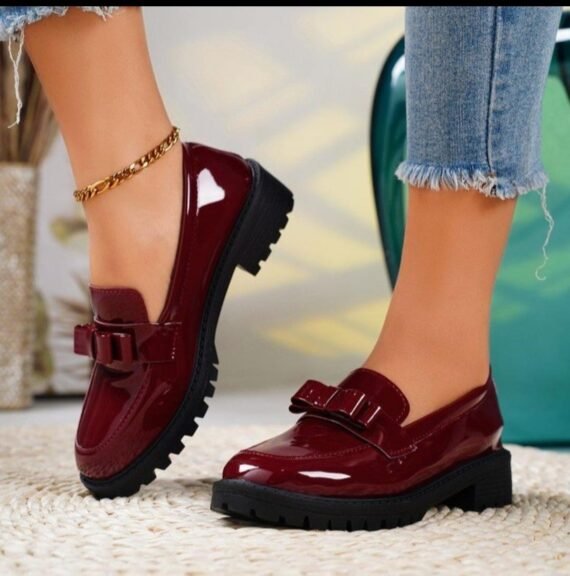 Step into timeless elegance with our Women's Patent Leather Loafers. Crafted from high-shine patent leather, these loafers feature a classic silhouette with a modern twist, offering a luxurious finish that instantly elevates your look. The slip-on design ensures effortless wear, while the cushioned insole and sturdy sole provide lasting comfort for all-day use. Perfect for the office, weekend brunch, or a chic casual ensemble, these loafers blend classic charm with contemporary polish for a truly versatile footwear essential.