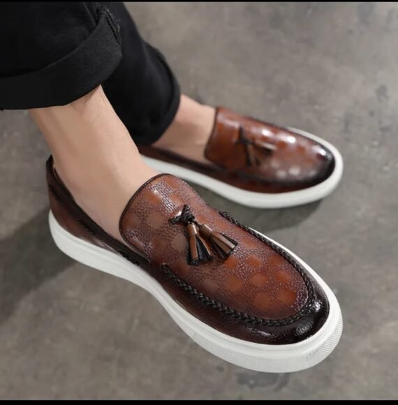 Elevate your ensemble with the Brown VersaTassel Loafer—featuring a rich brown hue, premium leather construction, and a sleek silhouette that complements both formal and casual outfits.