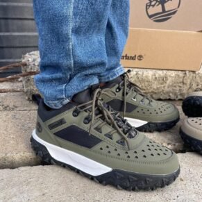 Sneakers and loafers in olive green, black, and white, showcasing Timberland's signature design and quality.