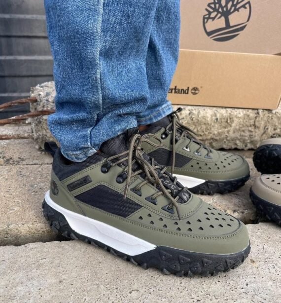 Sneakers and loafers in olive green, black, and white, showcasing Timberland's signature design and quality.
