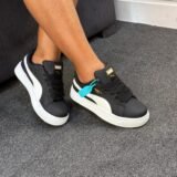 Sneakers on a person's feet, showcasing the Puma Cravat's sleek design and comfortable fit.