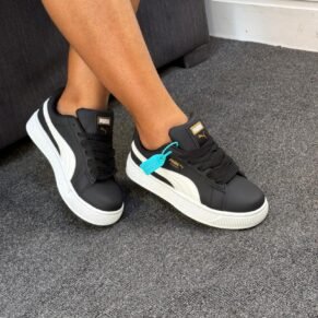 Sneakers on a person's feet, showcasing the Puma Cravat's sleek design and comfortable fit.