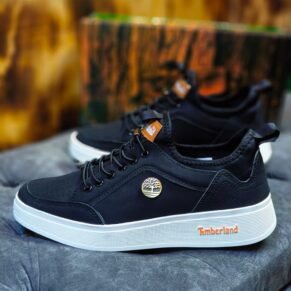 Sneakers with a black upper, white sole, and Timberland logo. Designed for Nigerian shoppers.