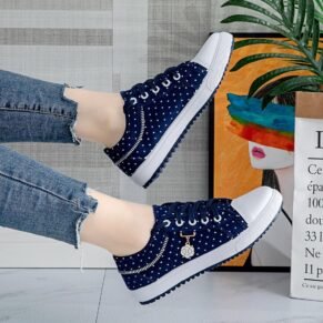 Sneakers with a polka dot pattern, white soles, and a small rhinestone embellishment. Featuring a comfortable fit and breathable upper.