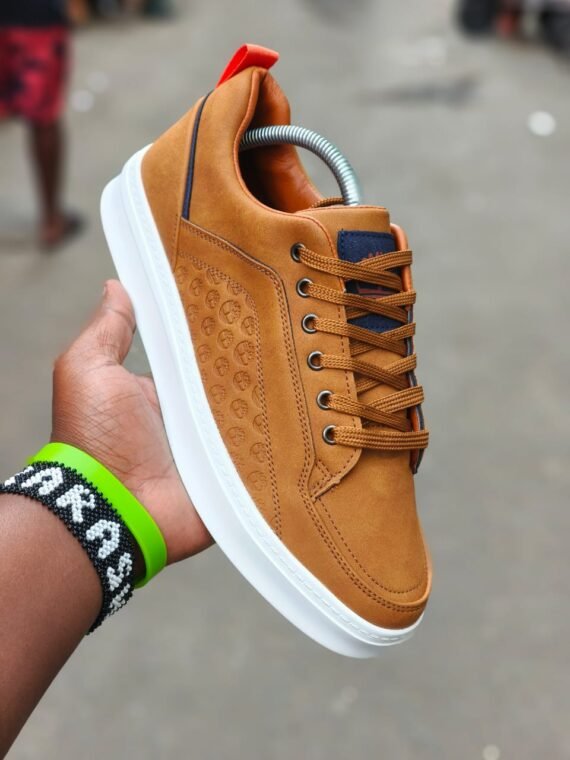 Sneakers with a unique pattern and vibrant orange laces. Designed for all-weather wear and a stylish touch for any outfit.
